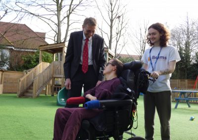 Steve Rozier, Head of Charity talking with a Child and assisted by a We Are Beams Carer.